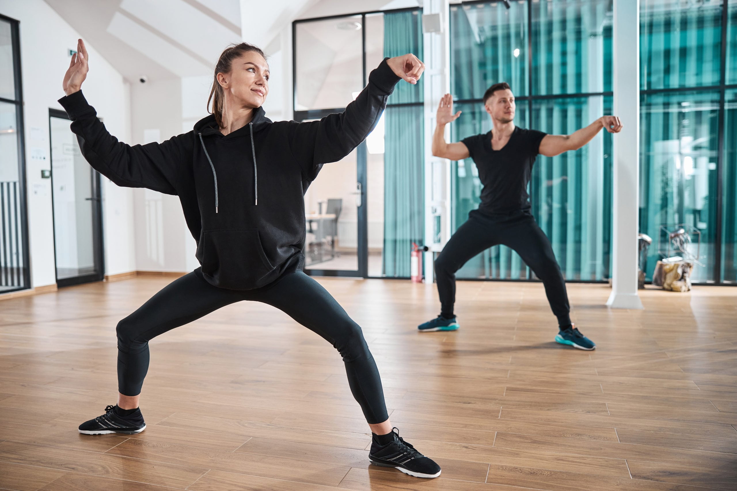 Pair of athletes training a single whip pose
